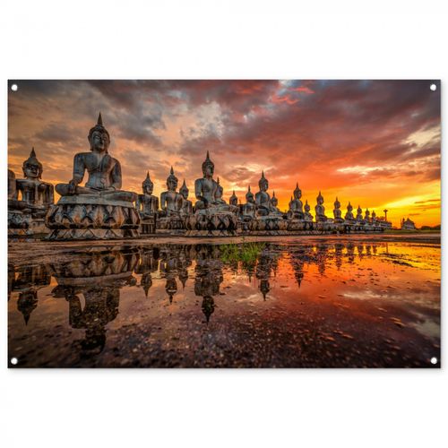 Tuinposter - Rij van Boeddha-beelden bij zonsondergang